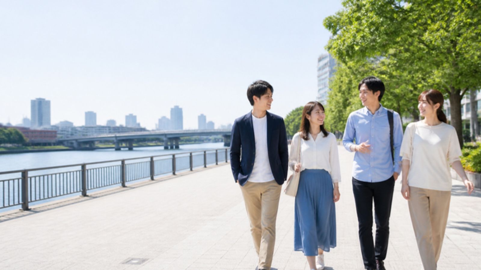 川沿いを話しながら歩く20代の男女
